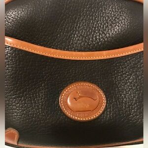 Dooney Bourke Small Handbag - Black with Camel or Tan edges details.